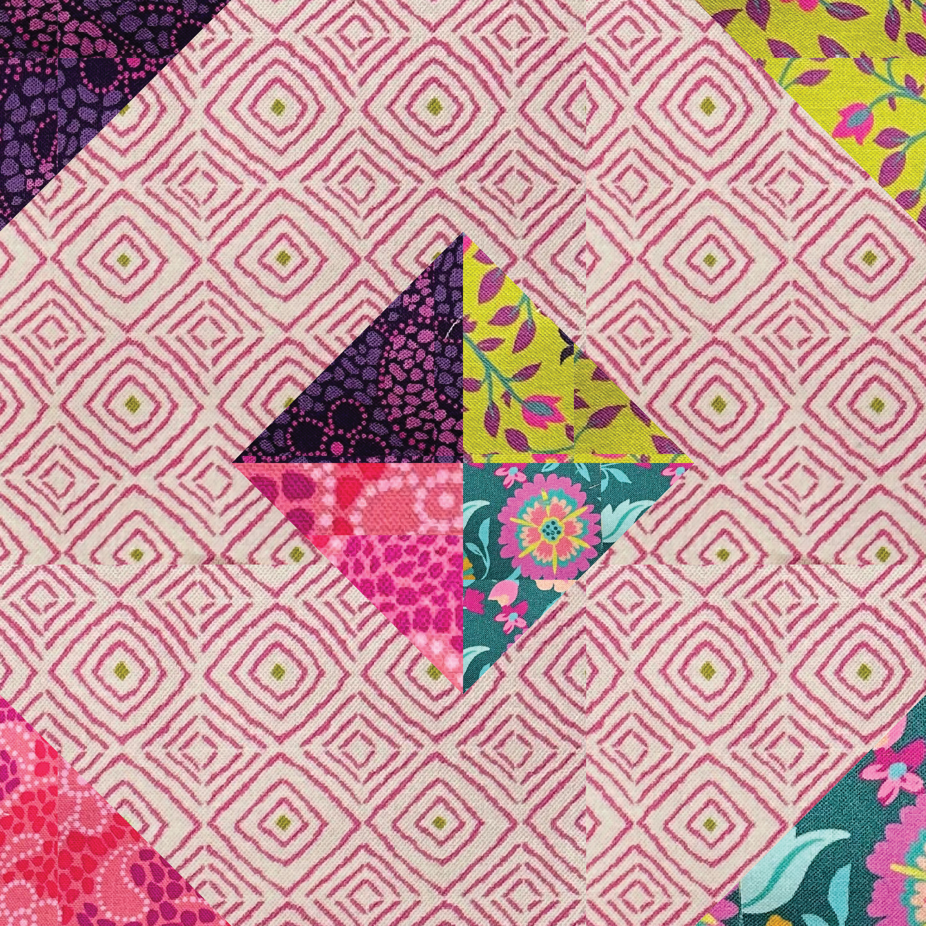 Colorful patchwork quilt block with geometric and floral patterns on a pink background