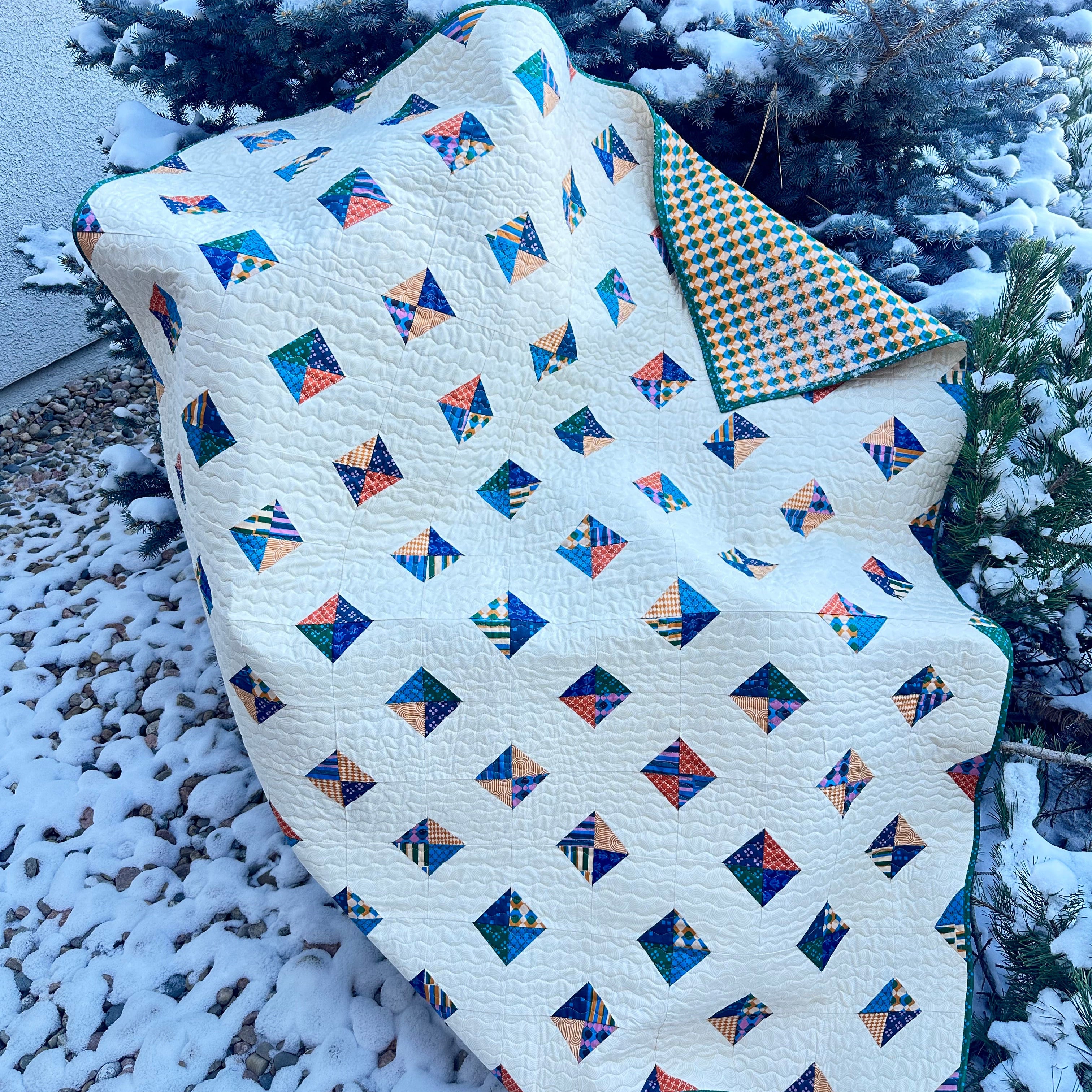 Quilt with geometric pattern on a snow-covered surface